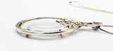 Elegant Magnifying Glass Rose Pendant on Gold Tone Metal Necklace