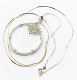 Elegant Magnifying Glass Rose Pendant on Gold Tone Metal Necklace