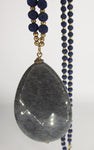 Mystic Faceted Grey Gemstone Pendant on Blue Wood and Golden Bead Necklace